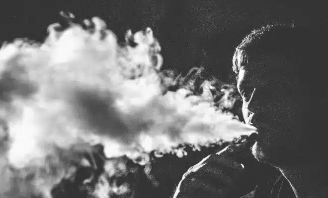 grayscale photography of smoking man